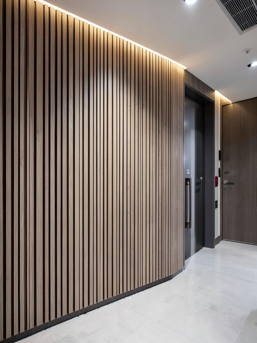 Finished wooden slat wall paneling with linear lighting